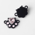 Macro detail of alloy cat paw charm connectors with pink crystal inlay for DIY jewelry - Black Base