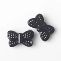 Macro detail of glossy black butterfly beads with textured wings for DIY jewelry - Black