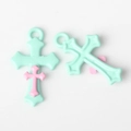Detail von minzgrünen und rosa geschichteten Kreuzanhängern für DIY-Schmuckherstellung - Grün