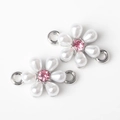 Macro detail of silver flower pendant with white pearls and pink crystal center - Silver