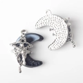 Detailed view of moon and star charms with marble resin inlay and sparkling crystals - Silver Base Black