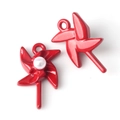 Detailed macro view of red windmill pendants with pearls for DIY jewelry making - Red