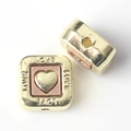 Macro detail of square gold beads with pink hearts and LOVE engraving for DIY jewelry - Brown