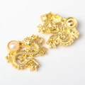 Detailed close-up of golden dragon pendants with pearl inlay and scale textures for DIY jewelry - 14K Gold