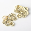 Detailed close-up of golden dragon pendant with pearl inlay for DIY jewelry crafting - Gold