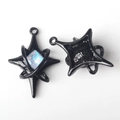 Macro detail of black star pendants with blue zircon inlay and polished metal finish - Black With Blue Crystal