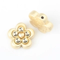 Macro detail of gold flower alloy beads with heart motif and side holes for DIY jewelry - Gold