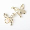 Detail of alloy butterfly charms with opal inlay and smooth metallic back texture - Gold Base White Stone (WSX-2674)