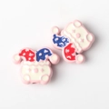Macro shot of colorful clown spacer beads for DIY jewelry making and crafting - Pink
