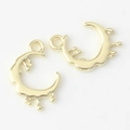 Detailed close-up of two irregular gold crescent moon pendants with a liquid metal texture - Gold