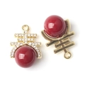 Close-up of red pearl charms with gold Xi character and diamond inlay for jewelry making - Double Happiness Style / Gold Base Red