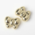 Detailed close-up of golden alloy bow beads with beaded edges for DIY jewelry making - Gold