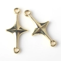 Close-up of golden alloy four-pointed star connectors with double loops for DIY jewelry - Gold