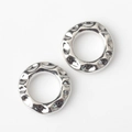 Macro detail of silver geometric rings with irregular hammered texture for DIY jewelry - Silver
