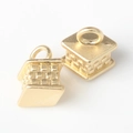 Detailed view of 3D geometric gold cube charms with intricate woven texture and top loops - Matte Gold