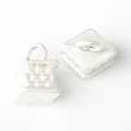Macro detail of silver square pendants featuring a 3D woven grid embossed texture - Silver White