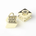 Macro shot of 3D geometric gold cube charms with intricate mesh texture for DIY jewelry - Gold