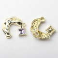 Detail of horseshoe-shaped gold metal pendant with purple gemstone and hanging loop - Purple Stone Gold Base