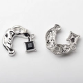 Macro view of C-shaped alloy charm with black gemstone and textured metal finish - Black / Silver Base