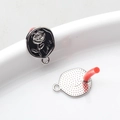 Macro shot of silver alloy rose earring charm with Love engraving and dotted back texture - Silver-Black