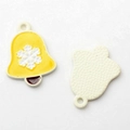 Macro shot of yellow enamel Christmas bell charms with snowflake detail and matte back - Yellow Bell White Base
