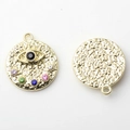 Macro detail of gold plated Evil Eye pendant featuring multi-color rhinestones and hammered texture - Multicolor Gold