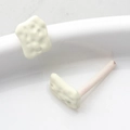 Detailed macro view of cream geometric biscuit-shaped DIY earring jewelry findings - White