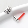 Detail of irregular geometric silver stud earrings with a unique hammered lava texture - Silver