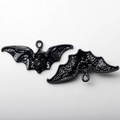 Detail of bat-shaped enamel charms with skull engraving and integrated hanging loop - Small Bat Black