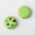Detailed view of 10mm green alloy bean beads with colorful enamel dots for DIY jewelry - Green