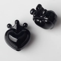 Macro-detail van zwarte hart hangers met kronen voor DIY-sieraden maken - Zwart