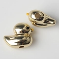 Macro shot of two golden duck charms with pre-drilled holes for DIY jewelry making - Gold