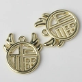 Macro detail of golden Fu character charms with openwork deer horn design for DIY jewelry - Gold