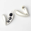 Macro view of silver alloy heart pendants with black faceted stones and back structure - Silver Black Stone