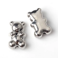 Macro detail of silver bear alloy beads showing front carving and back hole for DIY jewelry - 20 Pieces Set / Silver