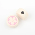 Close-up of cream round beads with pink flower patterns for DIY jewelry making - Off White