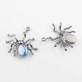 Makro-Detail von Spinnenanhängern aus Legierung mit blauen Steinen und Metallrückseite - Gunmetal