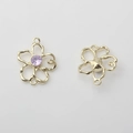 Nahaufnahme von goldenem Blumenanhänger mit lila Edelstein für DIY-Schmuckherstellung - Lila mit Goldrand