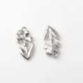 Detailed macro view of silver flower alloy charms showing front crystal and textured back - Silver / White Zirconia