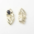 Detail of flower-shaped golden alloy pendant showing front stone and textured back view - Gold Base Black Rhinestone