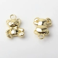 Macro shot of gold-plated teddy bear charms with detailed engraving for DIY jewelry - Gold Plating