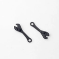 Macro detail of black matte alloy mini wrench charms for creative DIY jewelry making - Black