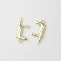 Close-up of mini gold-plated drill shaped charms for creative DIY jewelry making - Gold