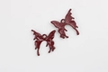 Detail of dark red butterfly alloy pendants with polished front and textured back finish - Dark Red