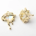 Detail of gold liquid heart pendants with iridescent resin and star zircons for DIY jewelry - Gold