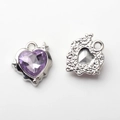 Macro detail of heart-shaped alloy pendant with purple gemstone and textured back - Silver Base + Purple Rhinestone
