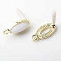 Detailed view of marquise-shaped golden earring bases with white resin inlays - White