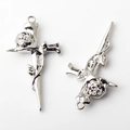 Macro shot of silver alloy cross pendants with detailed rose carvings for DIY jewelry making - Silver