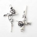 Detailed close-up of Gothic silver alloy cross pendant with rose and sword engraving - Antique Silver