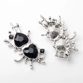 Detail of silver heart pendants with black crystals and fluid metal texture - Silver With Black Rhinestone